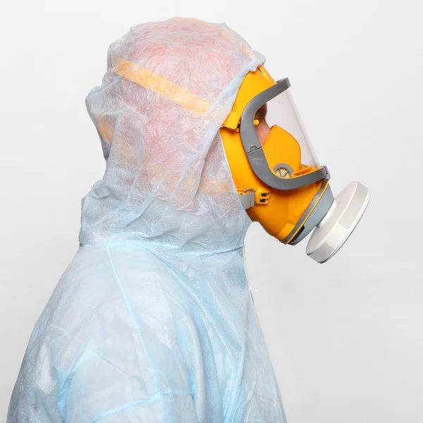 Man in protective clothing with respirator.