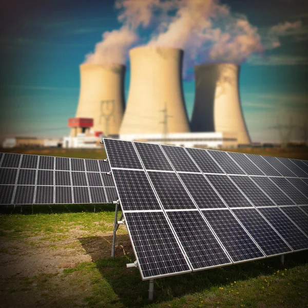 Solar panels against nuclear power plant.