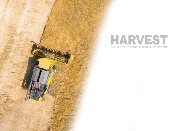 Aerial view of combine harvester on wheat field.