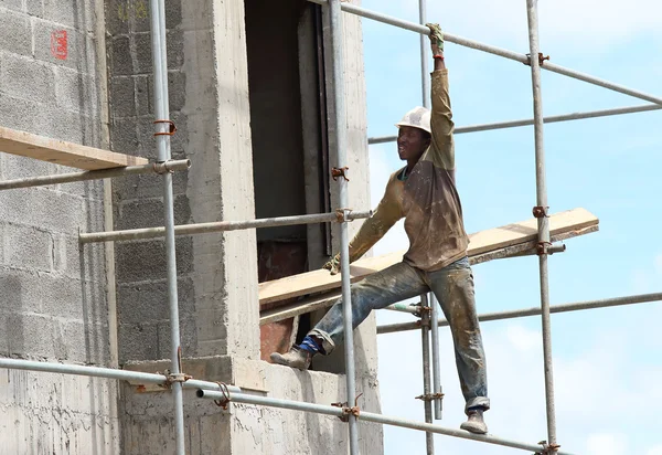 Unidentified African worker on a scaffold build new touristic resort