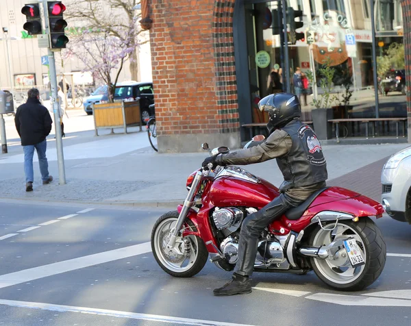 Motorcycle rider waiting at red light at Downtown Hannover