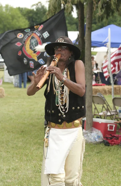 Famous Native American flutist Mike Serna playing his flute at Miami All Nations Gathering