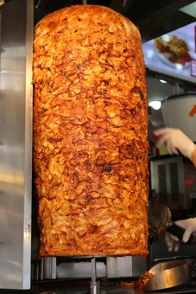 Chef slicing Chicken Doner Kebab at local restaurant in Beyoglu