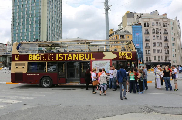 Tourists waiting departure of Big Bus Istanbul Tour Bus at Taksim Square