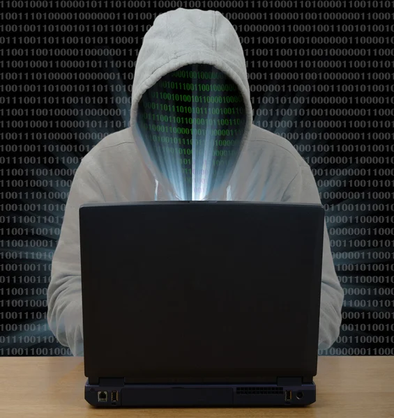 Hacker typing on laptop