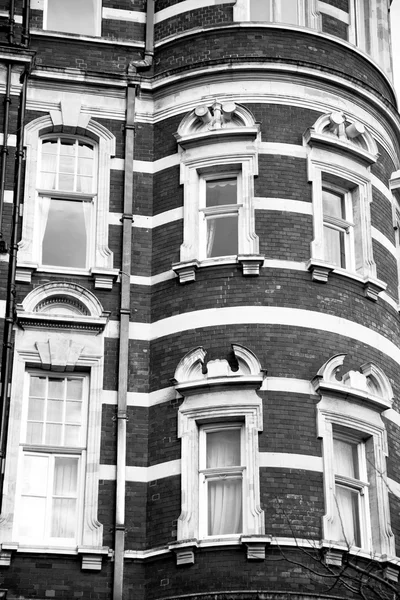 In europe london old red brick wall and      historical window