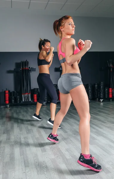 Women jumping in boxing training on gym