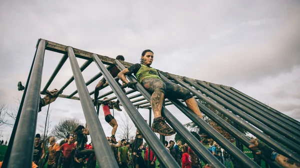 Runner going down structure in a test of extreme obstacle race