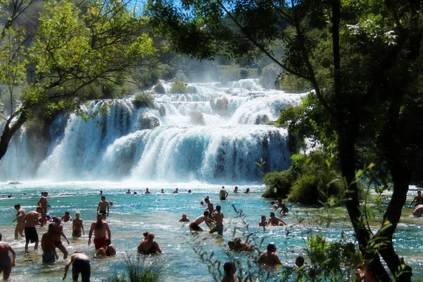 Tourists swimming in Krka National Park waterfalls, Croatia