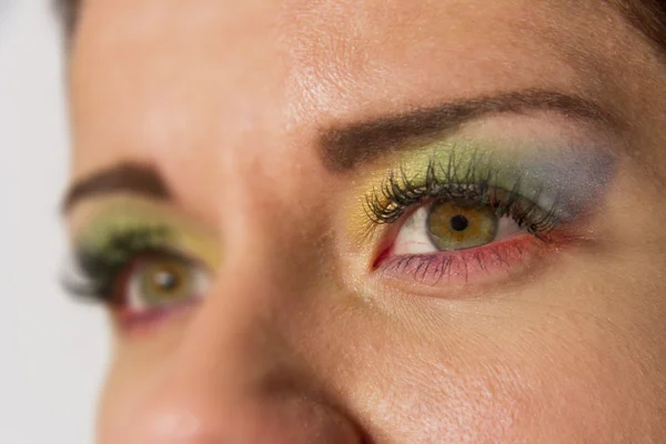 Eyes colored as beautiful rainbow. Hippy fashionable makeup style.