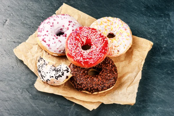 Donuts glazed with various sprinkles