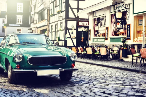 Retro car parked in city street