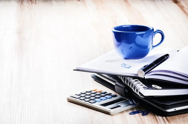 Business concept with agenda and coffee cup