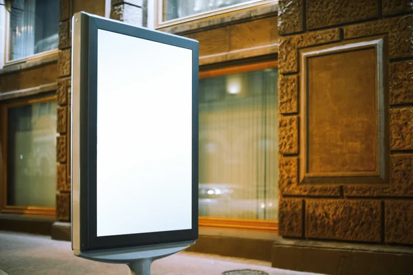 Modern advertising stand near old building