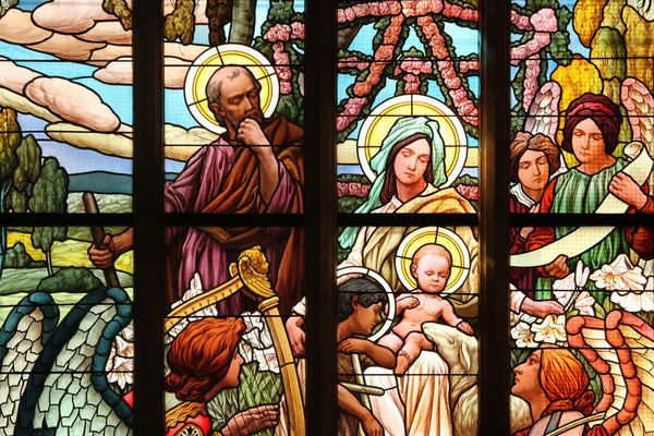 The Holy Family. Art Nouveau stained glass window.