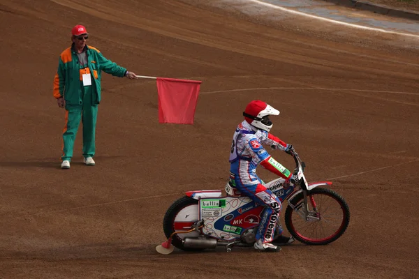 Referee with red flag and racer