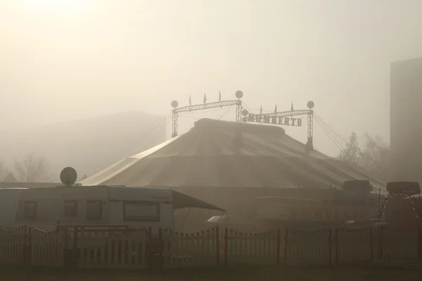 Morning fog covers the circus tent