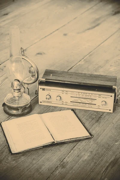 Kerosene lamp and radio and book