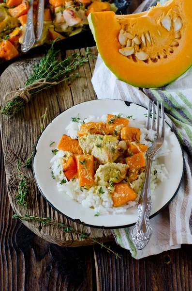 Pumpkin and chicken baked in cream with a side dish of rice