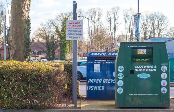 A collection bin for second hand clothes and shoes in a carpark