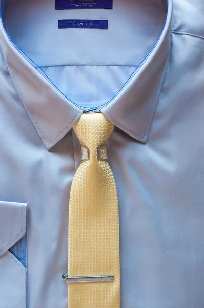 Blue cotton shirt and yellow tie with clip