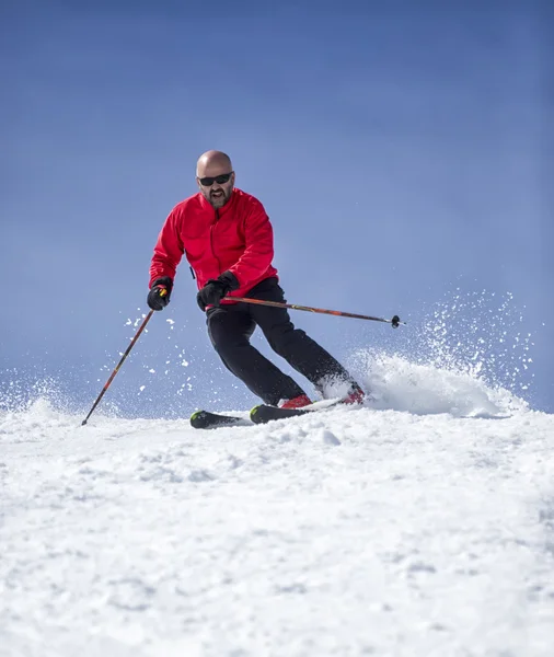 Skier sliding down the slopes