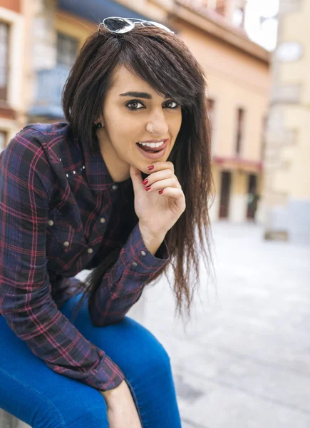 Brunette woman posing on the street