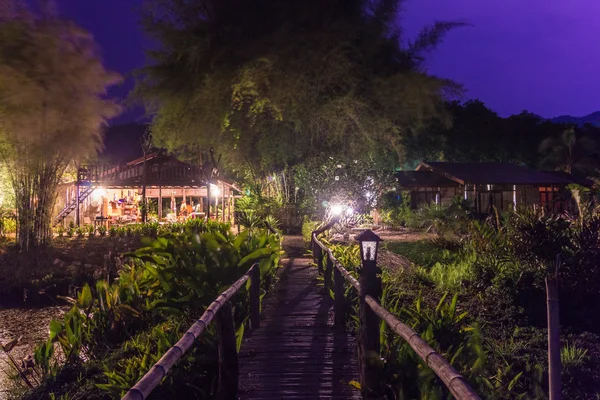 Bamboo bridge a foot path of resort at night