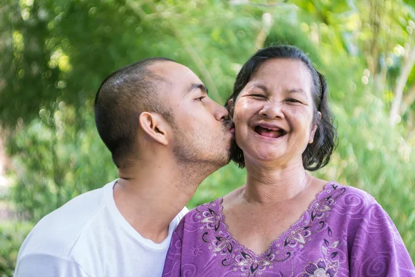 Son kiss his 60 years old mother