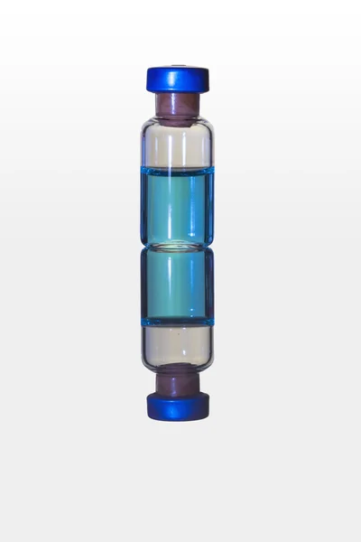 Medicine vial/Medicine vial containing blue liquid placed on a reflective surface