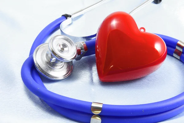 Medical instruments, stethoscope and red heart closeup shot