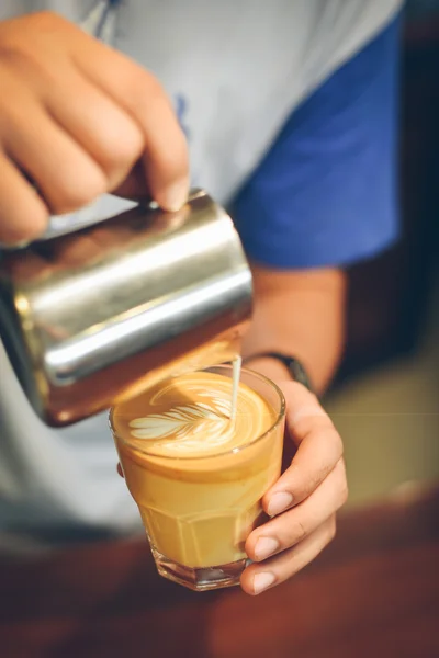 Coffee latte art in coffee shop vintage color tone