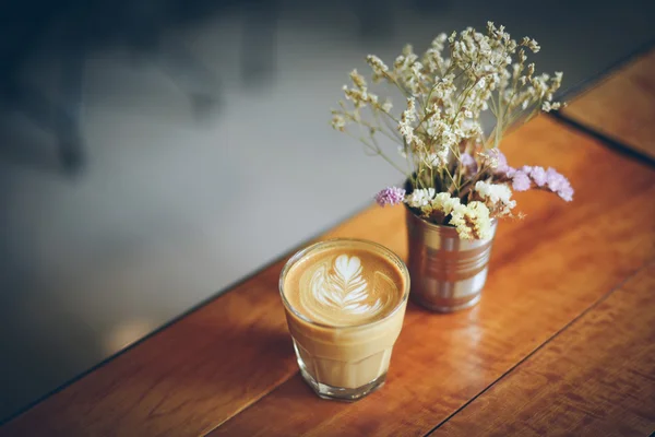 Coffee latte art in coffee shop vintage color tone