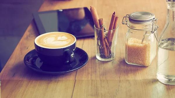 Coffee latte art in coffee shop vintage color tone