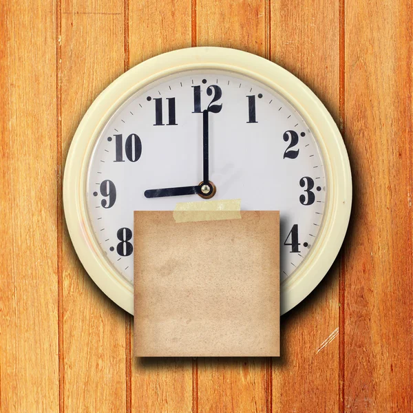 Wall clock on the wood background