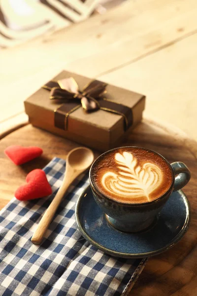 Vintage color tone of  cup of coffee with red heart on the table