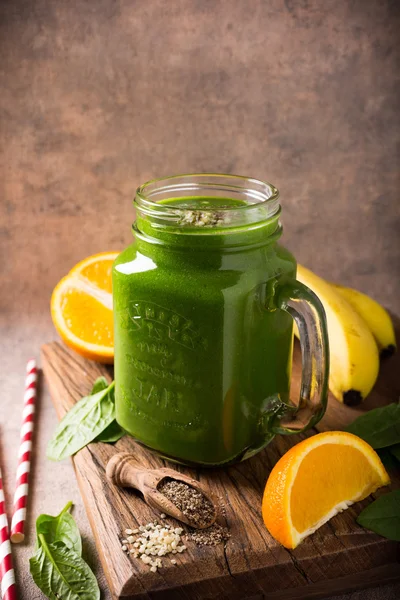 Healthy green smoothie with spinach in glass jar