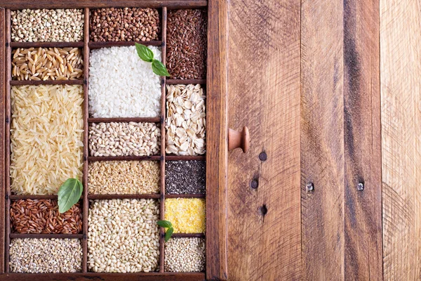 Variety of healthy grains and seeds in a wooden box