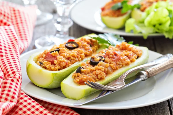 Stuffed squash with millet, tomatoes and olives