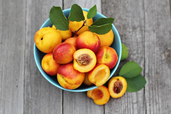 Fresh peaches in blue bowl