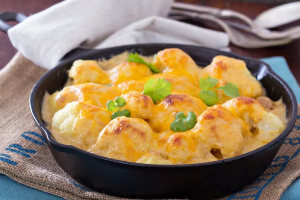 Cauliflower with cheese baked in a pan