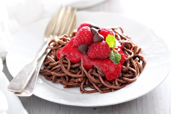 Cooked chocolate pasta with raspberry sauce