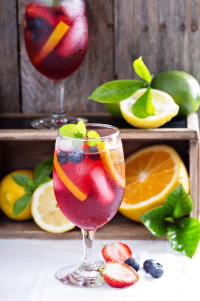 Ice cold red sangria with citrus fruits