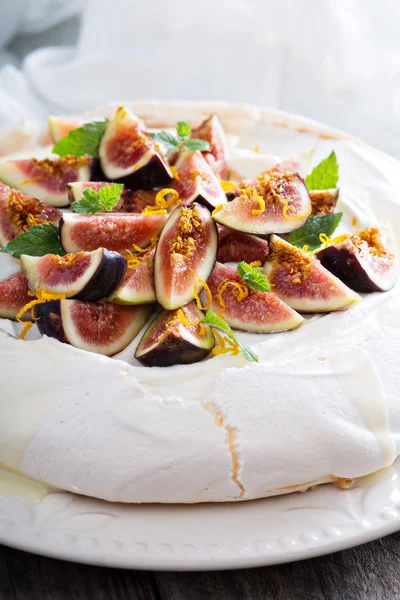 Pavlova cake with fresh figs and orange zest