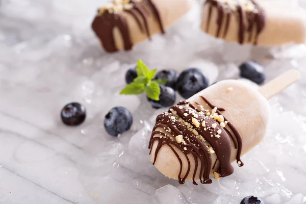 Banana and peanut butter popsicles with chocolate