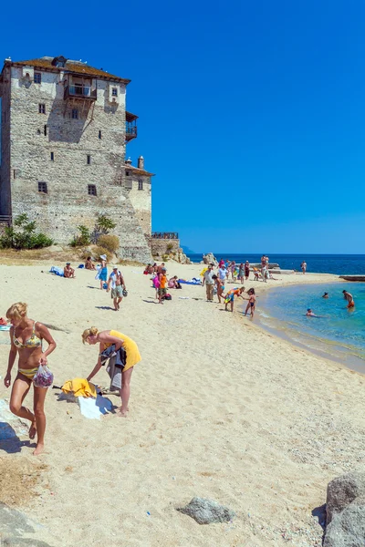 OURANOPOLIS, GREECE - JUNE 05, 2009: Tourists taking sun bath ne