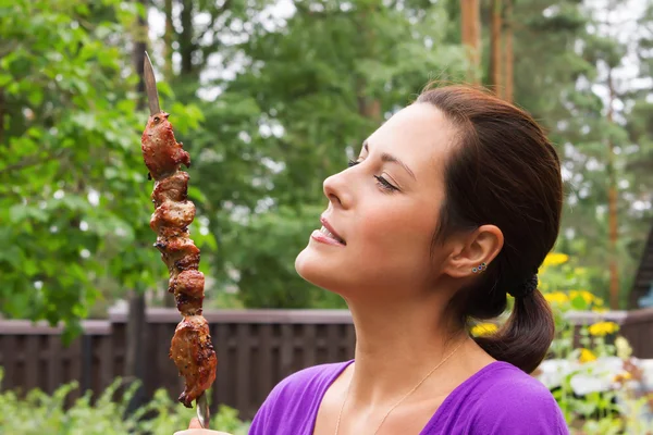 Woman enjoying barbecue outdoors