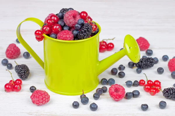 Mixed berries in small decorative watering can