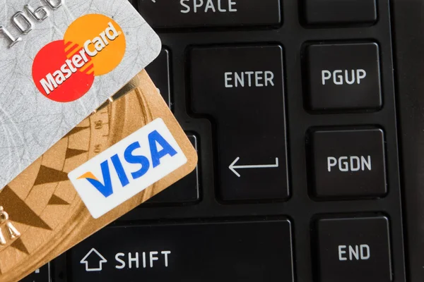 Credit cards on keyboard of notebook.