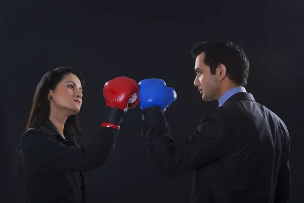 Businessman and businesswoman wearing  boxing  glowes